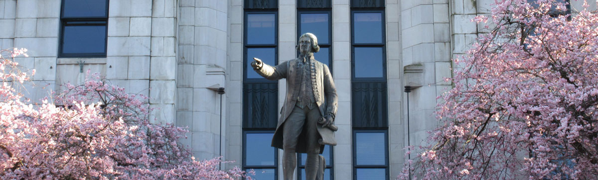 Accolade cherry blossoms at Vancouver City Hall with George Vancouver statue